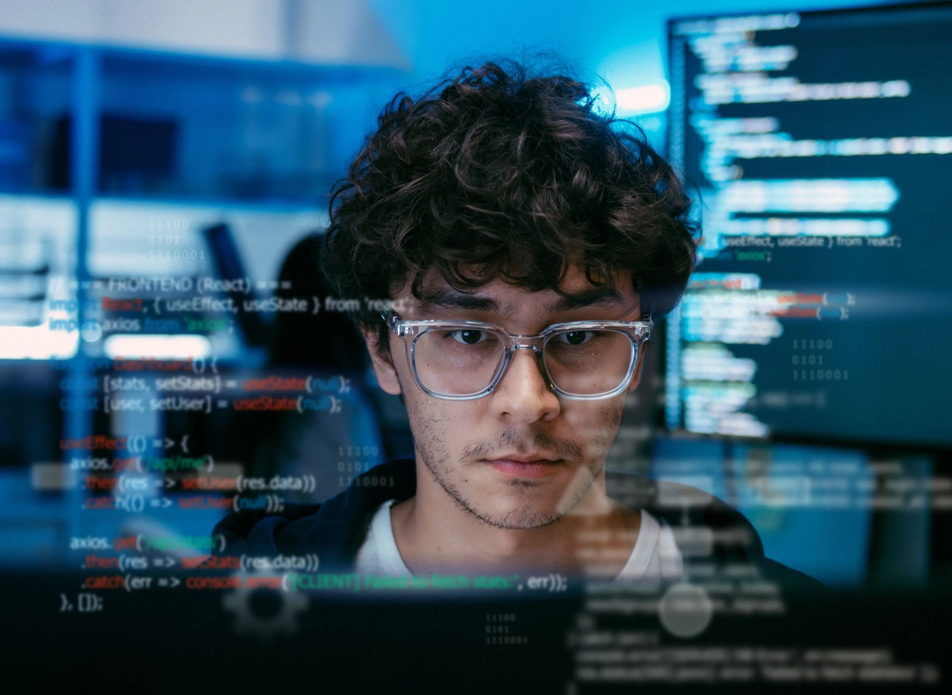 Cybersecurity professional working in front of code displays
